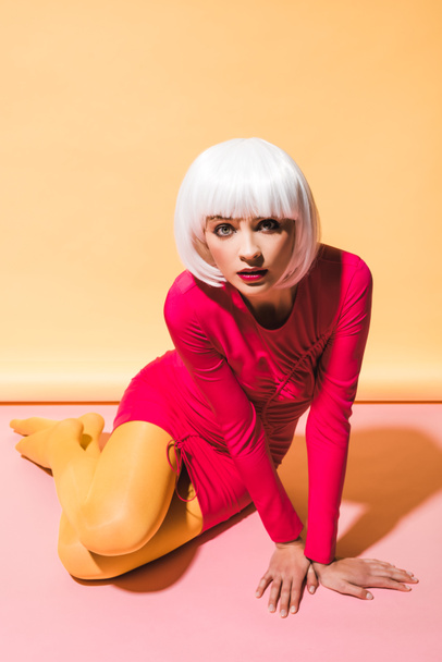 fashionable girl in white wig posing on yellow and pink - Photo, Image