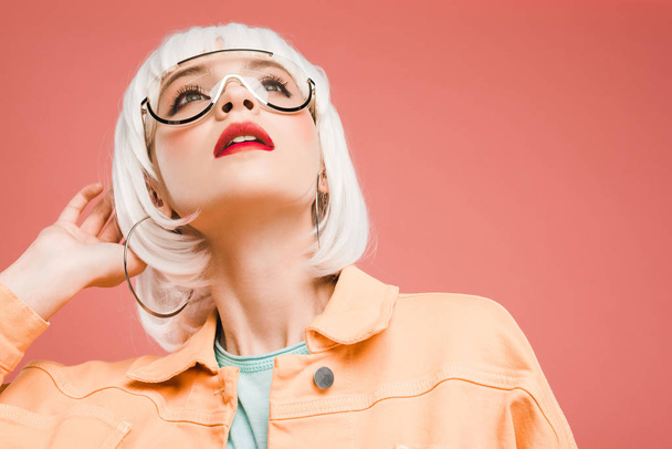 fashionable woman posing in sunglasses and white wig isolated on pink  - Фото, зображення