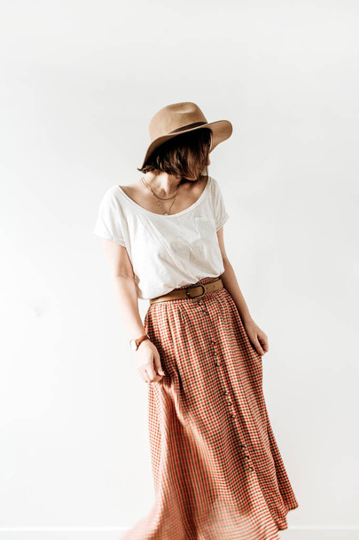 Young pretty woman in long skirt, hat, white blouse on white background. Fashion lifestyle trendy stylish clothes look. - Photo, Image