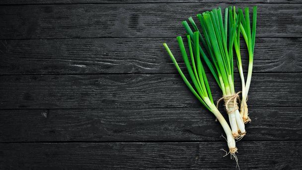Fresh green onion on a wooden background. Top view. Free space for your text. - Fotografie, Obrázek