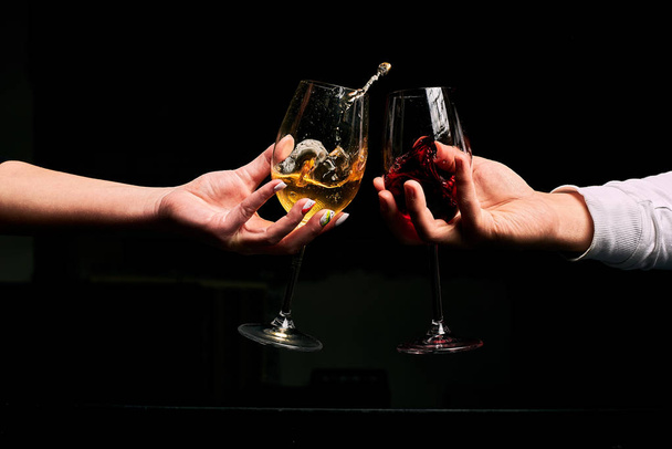 Partial view of couple clinking by wine glasses  - Fotografie, Obrázek