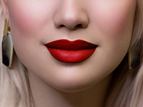 Cosmetics, makeup and trends. Bright lip gloss and lipstick on lips. Closeup of beautiful female mouth with red and pink lip makeup. Beautiful part of female face. Perfect clean skin - Fotografie, Obrázek