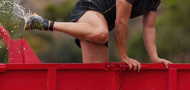 Runner in the container of ice water, race an extreme obstacle course - Photo, Image