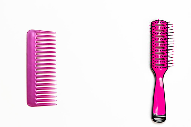 Pink hairbrush and a notebook on white background  - Valokuva, kuva