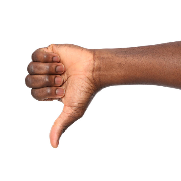 African-American man showing thumb down gesture on white background, closeup - Foto, Bild