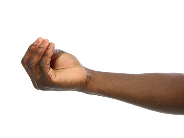 African-American man holding something in hand on white background, closeup - Foto, afbeelding