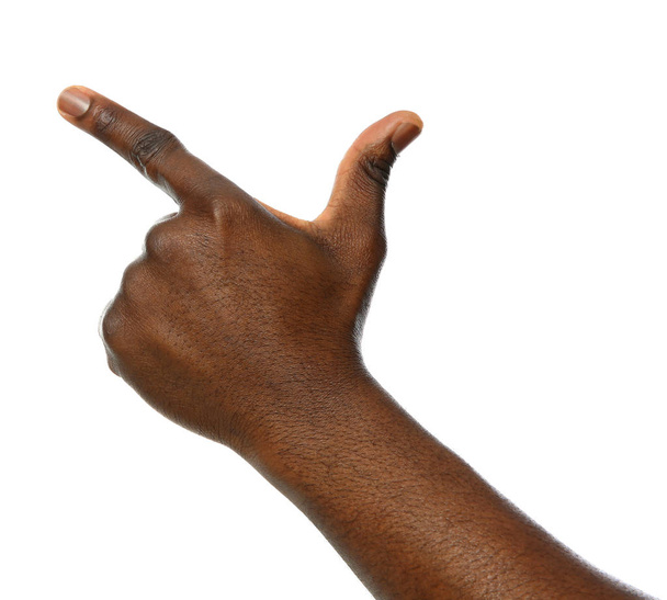 African-American man pointing at something on white background, closeup - Foto, Imagen