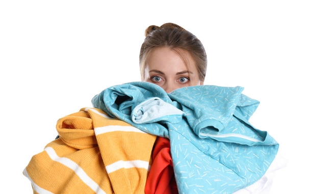 Young woman holding pile of dirty laundry on white background - Foto, Imagem