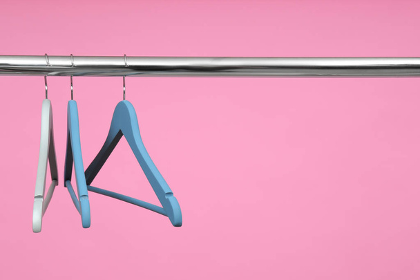 Empty clothes hangers on metal rail against color background. Space for text - Valokuva, kuva