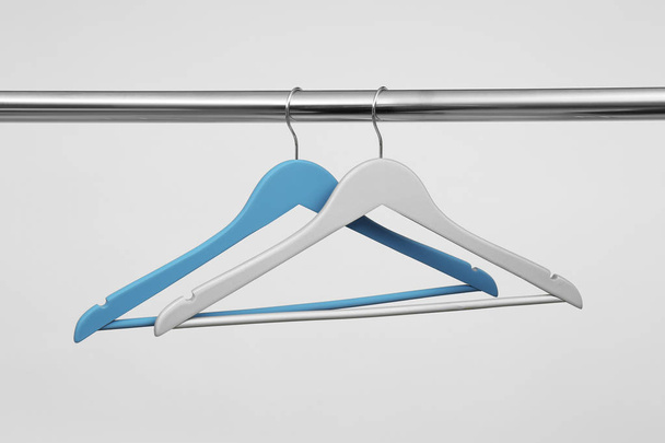 Empty clothes hangers on metal rail against light background - Fotó, kép