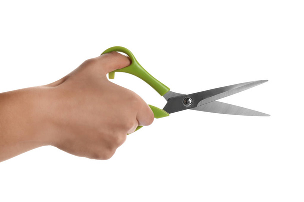 Man holding pair of sewing scissors isolated on white, closeup - 写真・画像
