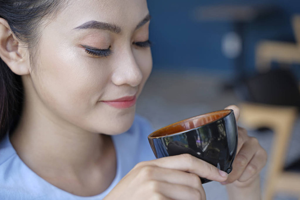Asian pretty attractive woman sitting in coffee shop using smart - Photo, image
