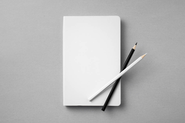 Design concept - top view of white notebook with wooden pencils on grey background for mockup. - Φωτογραφία, εικόνα