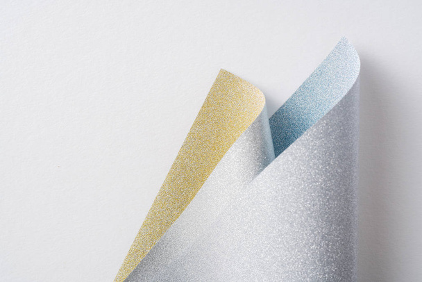 Design concept - silver and golden folded paper on golden background - Фото, зображення
