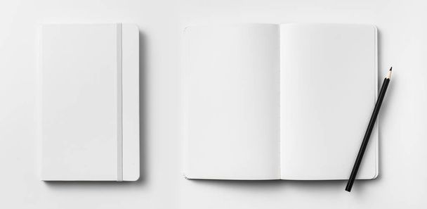 Top view of opened and closed white notebooks with elastic band and wooden pencil isolated on white background for mockup. - Fotoğraf, Görsel