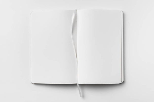 Opened white notebook and ribbon bookmark isolated on white background for mockup. - Foto, Imagem