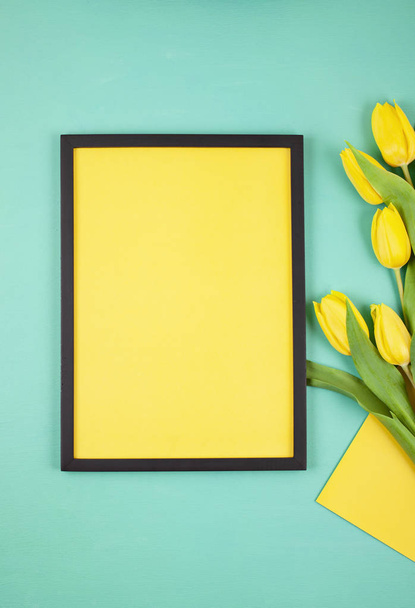 Decorative empty frame with copy space and bouquet of tulips - Photo, Image