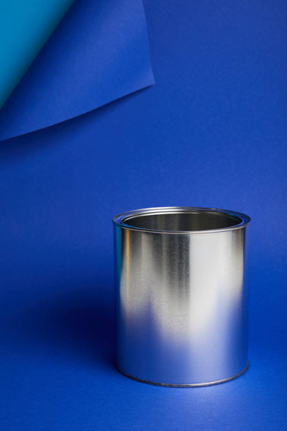 metal shiny can on bright blue background with copy space - Foto, immagini
