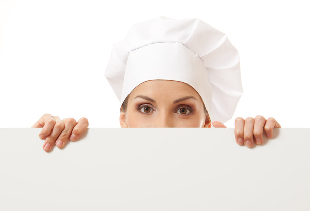 Woman cook looking over paper sign billboard. - Zdjęcie, obraz