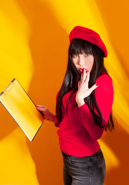 business woman yellow background red shadow beret brunette teacher glasses funny - Φωτογραφία, εικόνα
