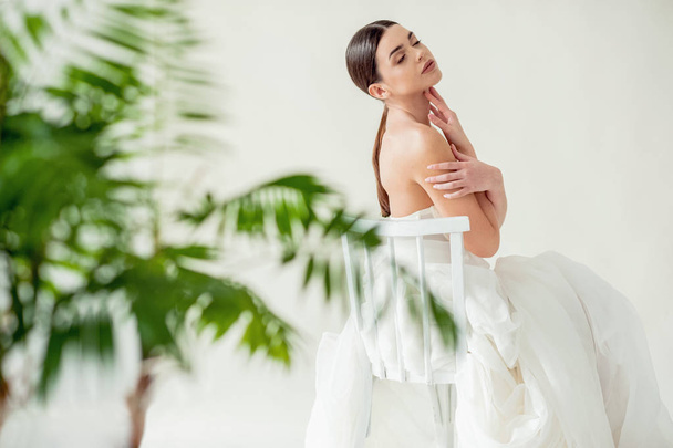 Beautiful sensual brunette model portrait in white lingerie on light background - Photo, Image