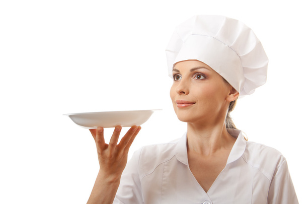 Woman cook holding empty plate - Photo, image