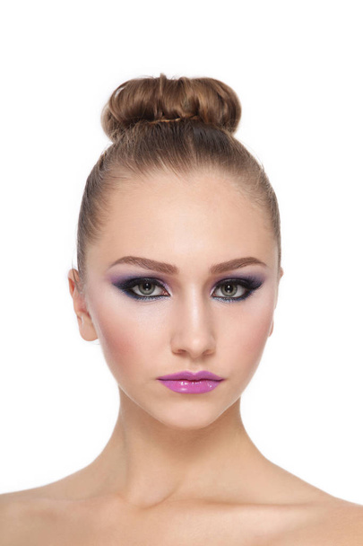 Young beautiful girl with hair bun and fancy makeup - Foto, afbeelding