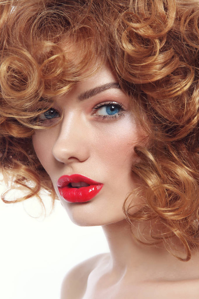 Young beautiful woman with curly hair and red lipstick - Foto, afbeelding