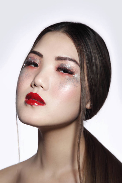 Portrait of young beautiful asian girl with fancy glitter makeup - Foto, Imagem