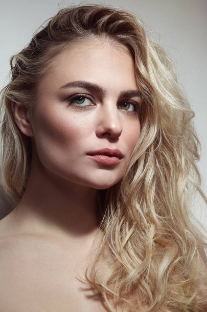 Portrait of young beautiful woman with blond curly messy hair - Φωτογραφία, εικόνα