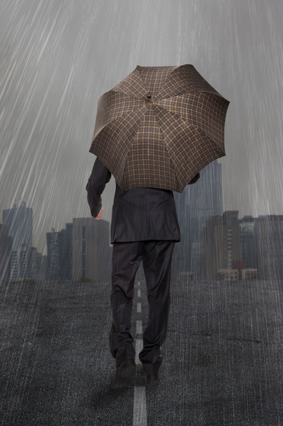Businessman with umbrella - Foto, Bild