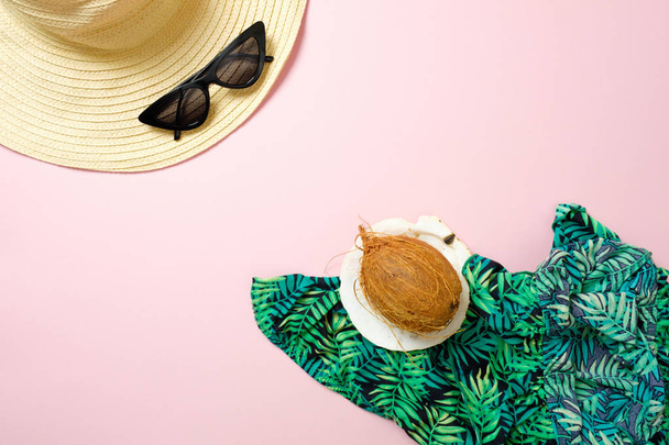 Flat lay summer women's accessories and coconut on pastel pink background with blank space for text. Top view travel or vacation concept. Summer background - Fotoğraf, Görsel
