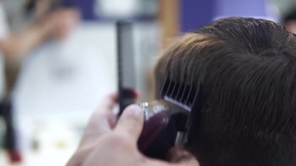 Fodrász, hajvágás elektromos borotvával. Hajvágó vágás - Felvétel, videó