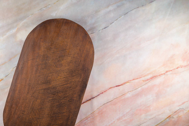 Wooden cutting board on a gray marble background - Φωτογραφία, εικόνα