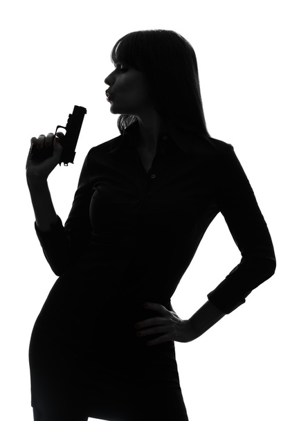 sexy detective woman holding aiming gun silhouette - Foto, Imagem