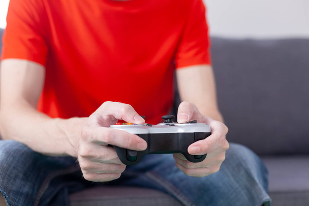 Young man plays video game using a gamepad - Foto, Imagem