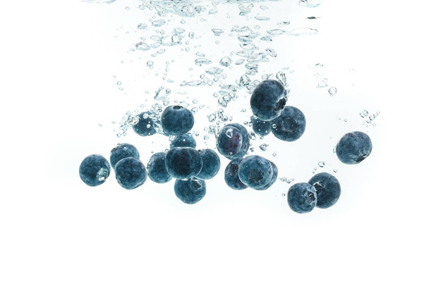 Blueberries falling into water. - Фото, зображення