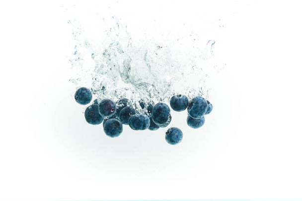 Blueberries falling into water. - Fotoğraf, Görsel