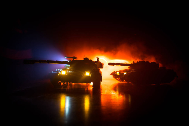 Sota-ajatus. Sotilaallinen siluetteja taistelevat kohtaus sodan sumu taivaalla tausta, Siluetti panssaroitu ajoneuvon alla pilvinen Skyline yöllä. Hyökkäyskohtaus. Tankkien taistelu. Taideteosten koristelu
 - Valokuva, kuva