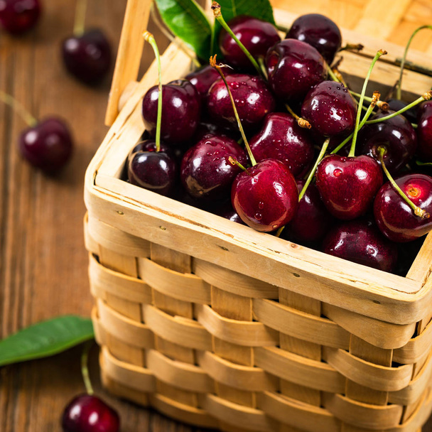 Cherries in a Wicker Basket Background. Selective focus. - Photo, Image