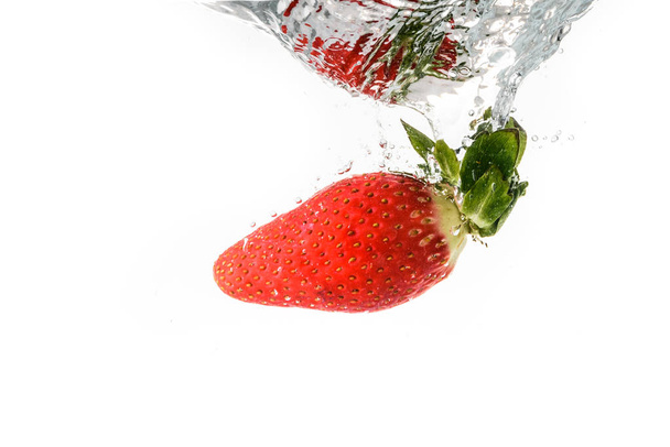 Strawberry splashing into crystal water - Photo, Image