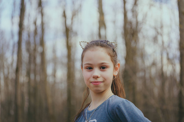 Portrait of a girl in casual clothes is standing on the playground - Фото, зображення