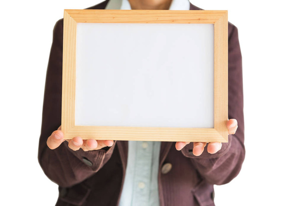 Blank wooden photo Frame in the woman's hand isolated on white background .Blank space for text and images of file with Clipping Path . - Foto, Imagem