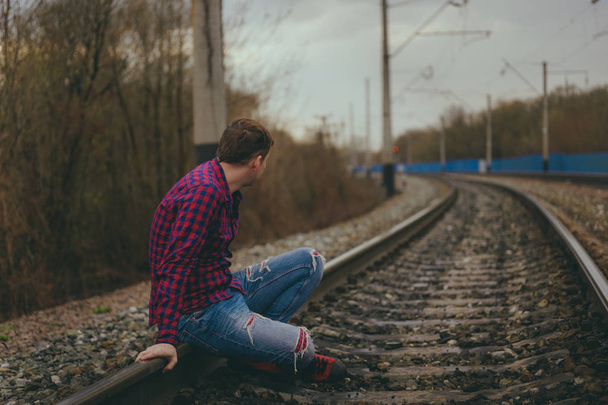 Trendy young man  on rails - Фото, изображение