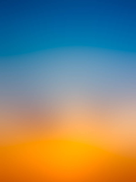 abstrakter Sonnenaufgang am Himmel mit blauem und orangefarbenem Hintergrund. - Foto, Bild