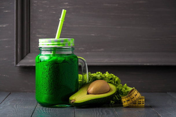Glass of fresh vegetable juice on gray wooden background. Healthy concept with copyspace. - Φωτογραφία, εικόνα