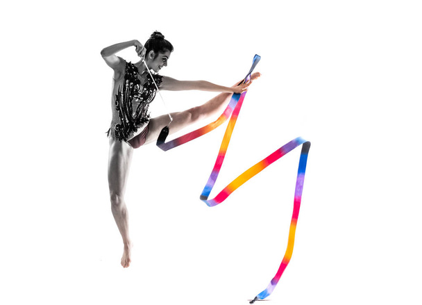 Girl doing rhythmic gymnastics with ribbon jumping - Zdjęcie, obraz