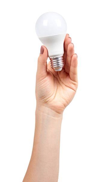 Hand with white LED bulb, eco friendly lamp, modern equipment. - Fotografie, Obrázek