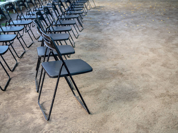 Rows of black metal folding chairs on the ground - Photo, Image