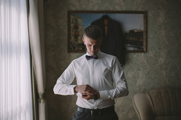 young stylish groom wears morning on his wedding day - 写真・画像